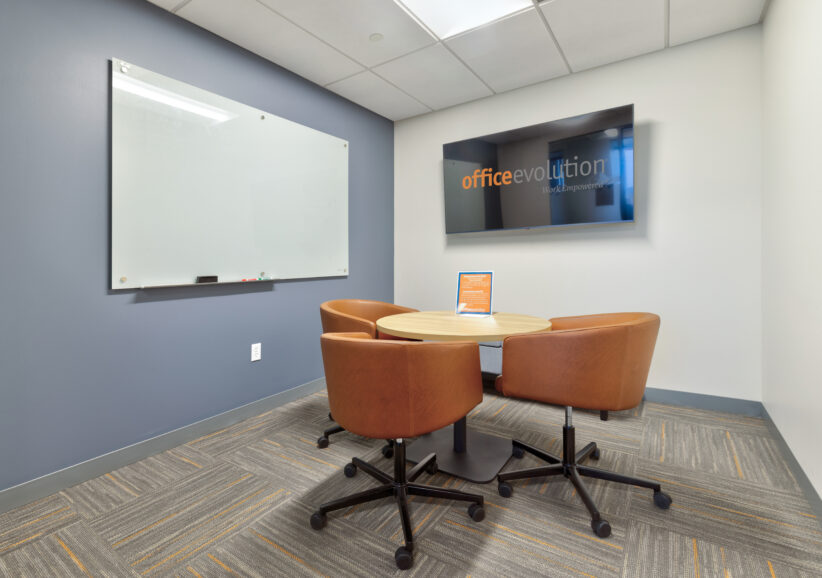 small huddle conference room good for laywers, real estate closings, consultations. Luxury leather seating, white board, and a large TV with display